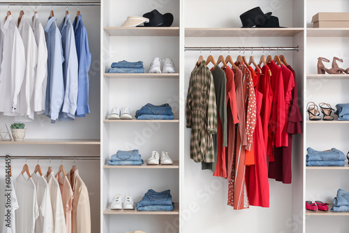 Shelves with stylish clothes and shoes in boutique
