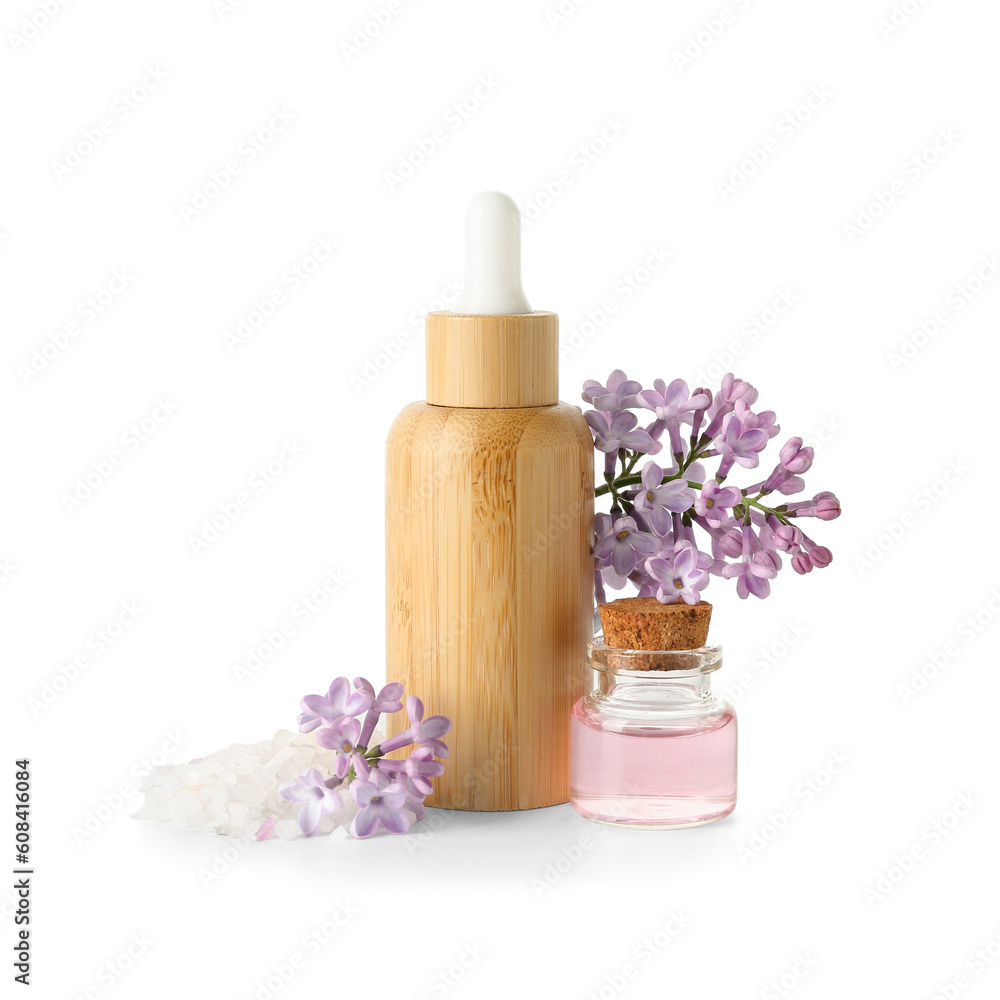 Bottles of cosmetic oil with beautiful lilac flowers on white background Bottles of cosmetic oil with beautiful lilac flowers on white background