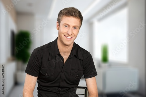 Young happy man posing indoor