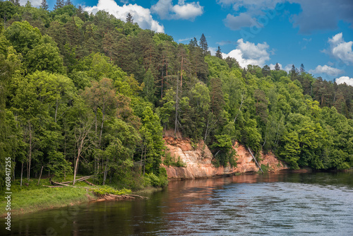 Landscape view of red sandstone caves on Gauja river in Sigulda  Latvia on a sunny summer day