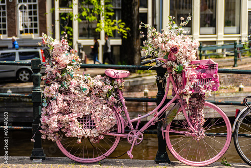 Photography Creatively decorated bicycles parked over the Amsterdam canals.