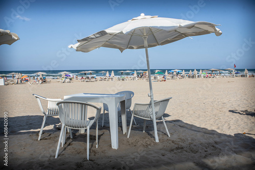 Chairs and tables placed on the beach of Gandia.