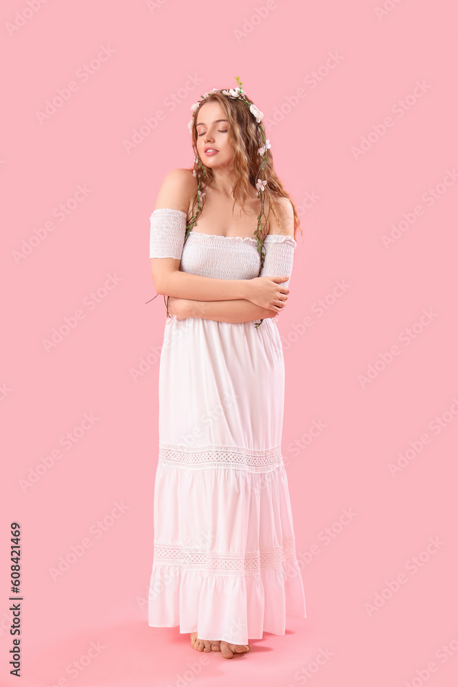 Beautiful young woman with flowers in her hair on pink background. Summer solstice Beautiful young woman with flowers in her hair on pink background. Summer solstice
