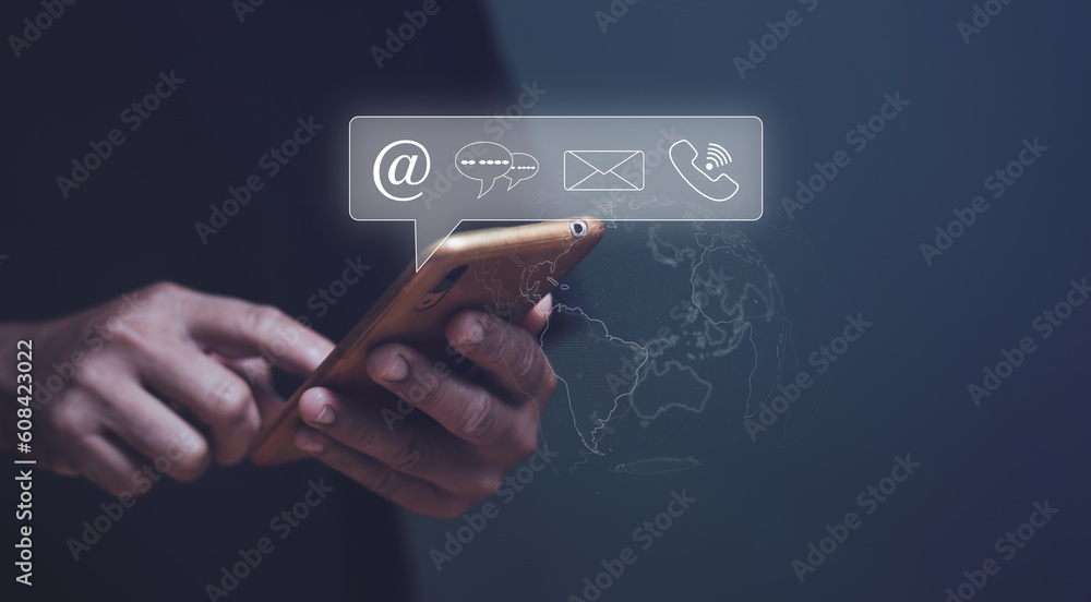 Businessman using mobile phone and touching on virtual screen contact icons (email, address, live chat, internet phone), Contact us or hotline customer information support connect. Businessman using mobile phone and touching on virtual screen contact icons (email, address, live chat, internet phone), Contact us or hotline customer information support connect.