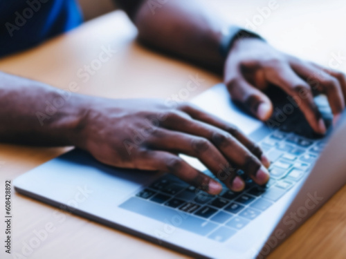 Close up of hands typing on a laptop keyboard, person working