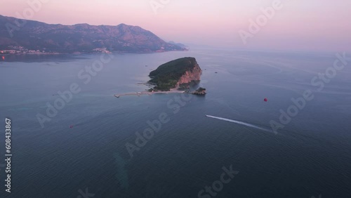 Aerial panoramic drone view of the beautiful Sveti Nikola Island near Budva city, dusk on a beautiful summer day, on the Adriatic Sea, Montenegro photo