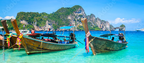 Traditional longtail boats near beautiful tropical island Ko Phi Phi, Thailand photo