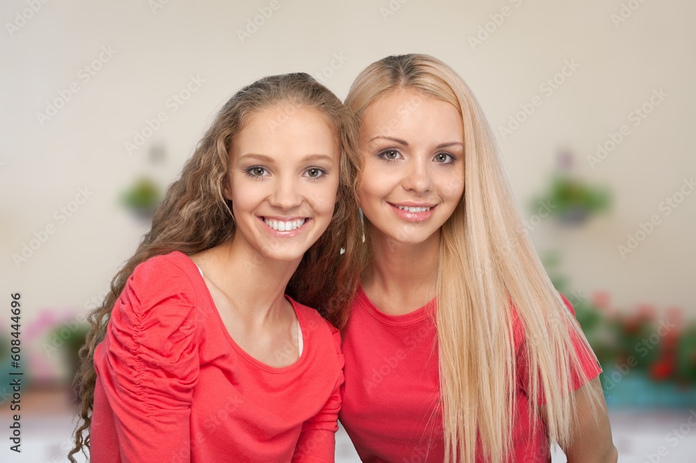 Smiling happy young women posing at the camera Smiling happy young women posing at the camera