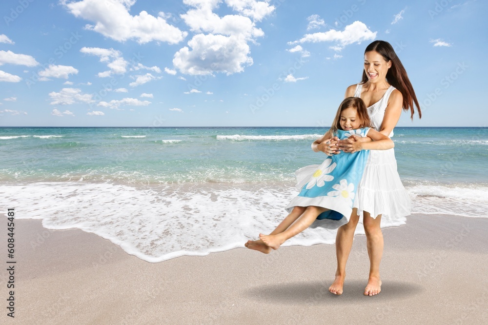 Playful young happy mother with child at beach Playful young happy mother with child at beach