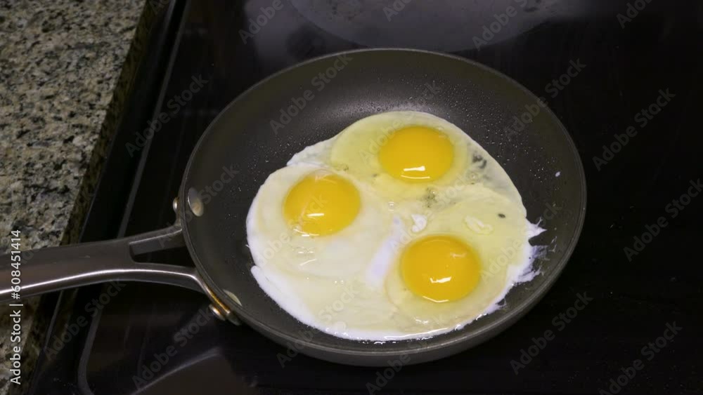 Shot of the eggs being cooked on a small pan Shot of the eggs being cooked on a small pan