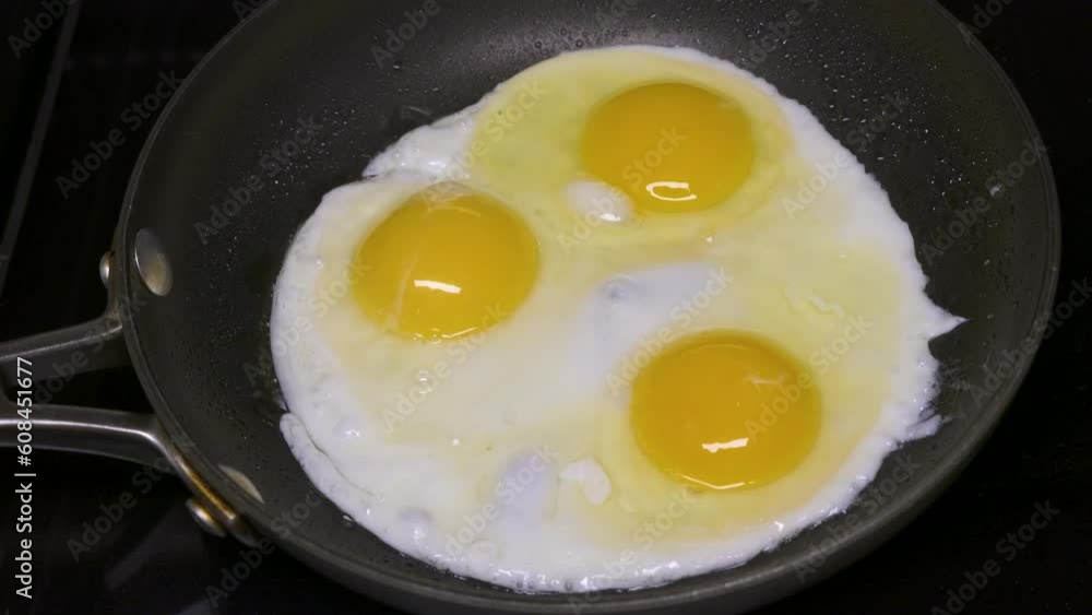 Cooking over easy eggs on a pan Cooking over easy eggs on a pan