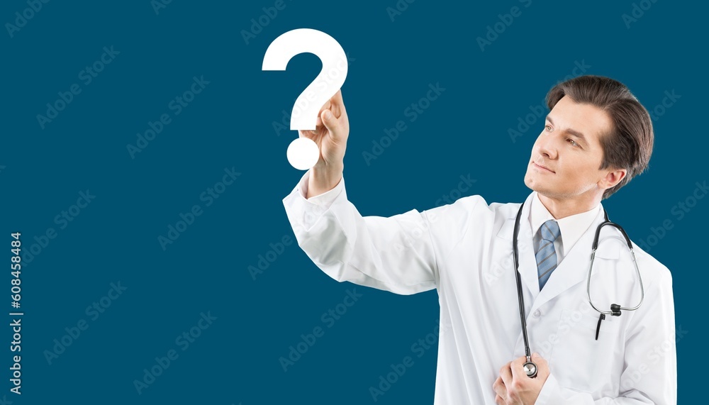 Hand of doctor holding a big question mark Hand of doctor holding a big question mark