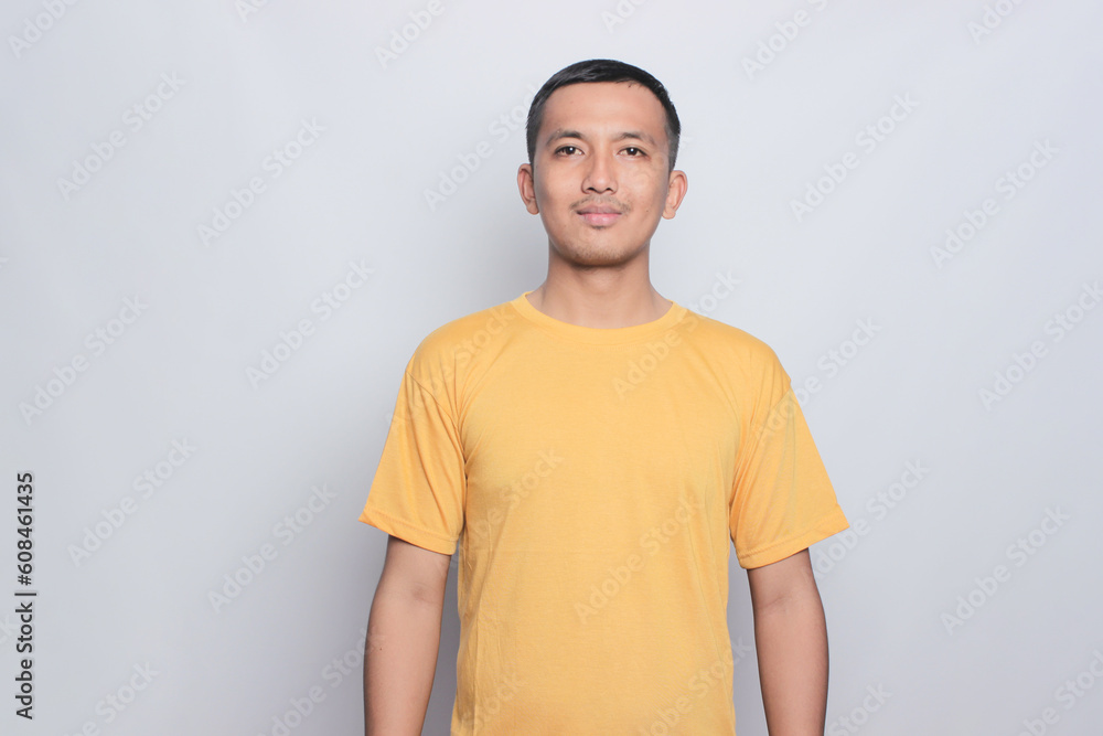 An Asian man wearing yellow tshirt for mock up. An Asian man wearing yellow tshirt for mock up.