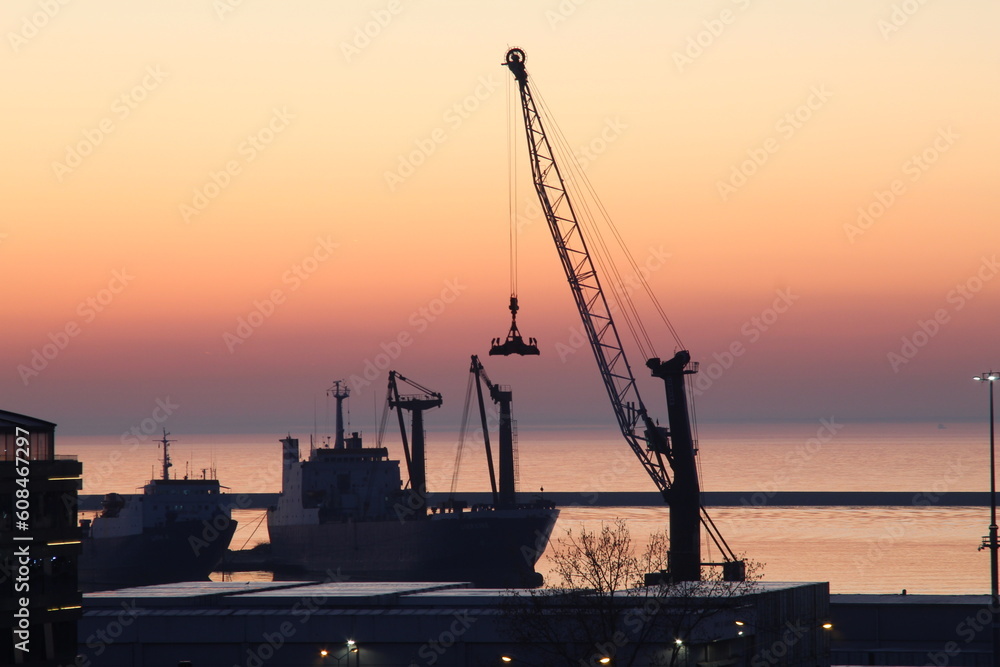 Sunrise at the pier with a crane silhouette