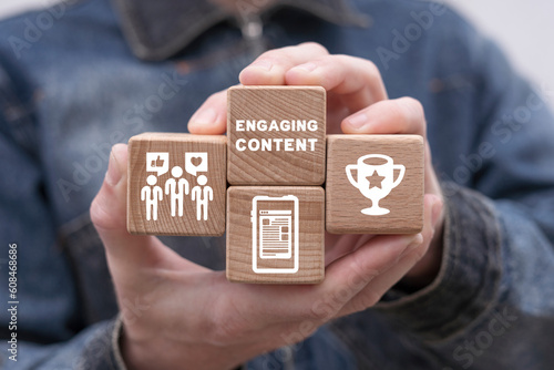 Photography Man holding wooden cubes with icons and inscription: ENGAGING CONTENT