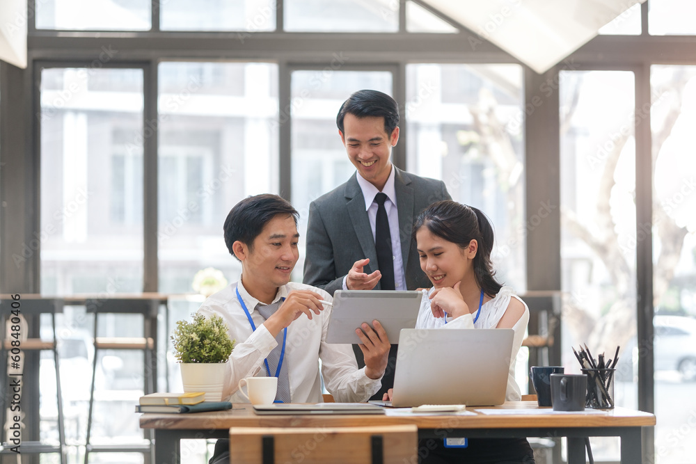 Group of happy business people using digital tablet while collaborating on a new project in modern workspace. Group of happy business people using digital tablet while collaborating on a new project in modern workspace.