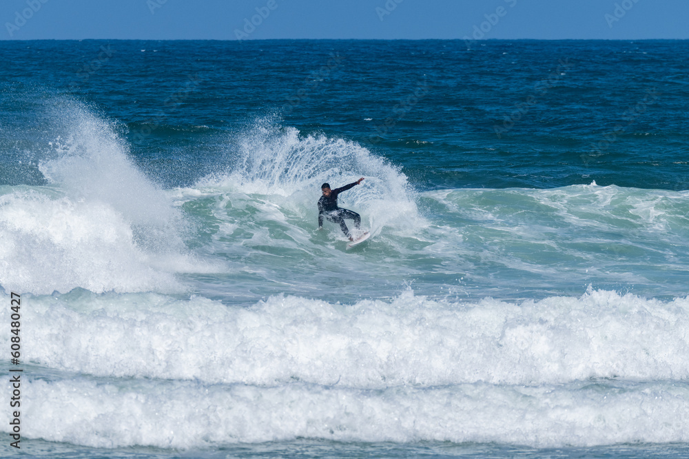 Surfer riding waves in Furadouro Beach Surfer riding waves in Furadouro Beach