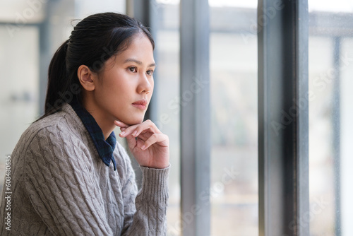 Free Download Pensive businesswoman sitting at office and looking away thoughtfully, dreaming, planning future. - GFXLoad