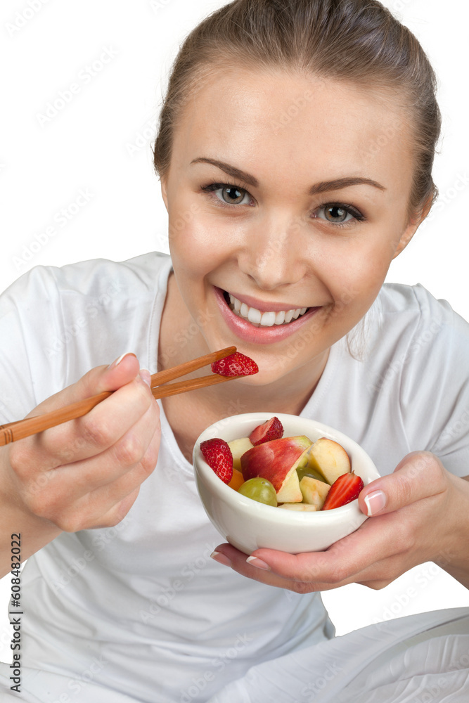 Pretty young woman eat fruit salad isolated on white background Pretty young woman eat fruit salad isolated on white background