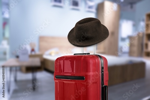 Suitcase or luggage with stylish hat in a hotel room