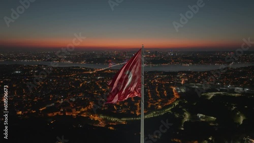 Aerial view of the glorious Turkish flag waving from the hill, which has the most beautiful view of Istanbul, which sees the bridge connecting Asia and Europe.