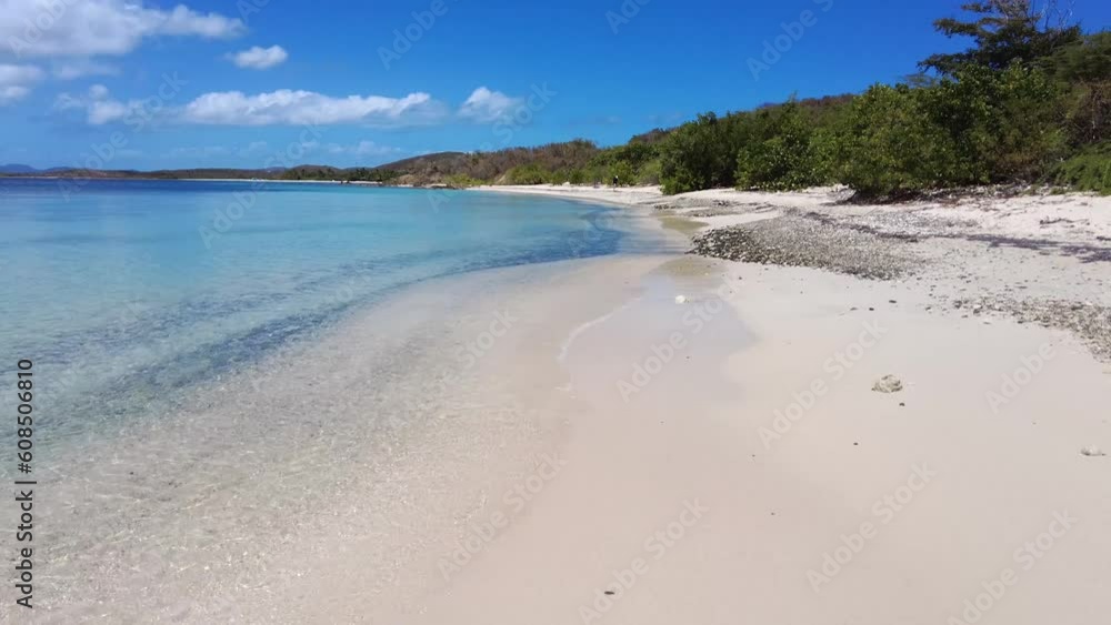 Walking on a beautiful tropical beach location in Puerto Rico with trees, sand and waves crashing. Walking on a beautiful tropical beach location in Puerto Rico with trees, sand and waves crashing.