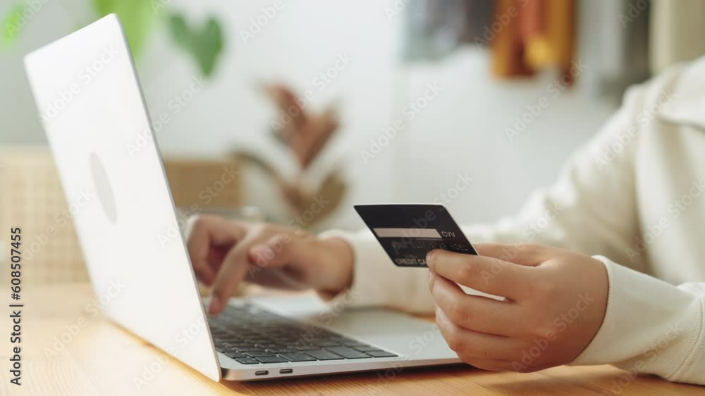 Hand. woman buying, transactions online with credit card on laptop at home Hand. woman buying, transactions online with credit card on laptop at home
