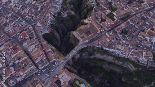 Slowly moving top down of Puente Nuevo arch bridge at the village of Ronda during sunrise, Aerial