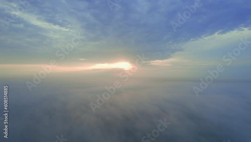 Wallpaper Mural Sunrise in the fog from a drone in Africa. The low down clouds light up from the rising sun, with blue and gold colours, over the bush below. Humid landscape after the rain season Torontodigital.ca