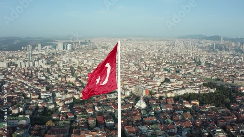Aerial view of the glorious Turkish flag waving from the hill, which has the most beautiful view of Istanbul, which sees the bridge connecting Asia and Europe.