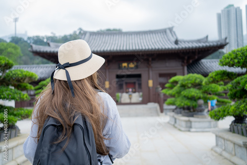 Asian tourist, cute woman with long hair are traveling in Hong Kong along with map and her camera with fun on her holiday, A temple in Hong Kong, concept travel. © maya1313