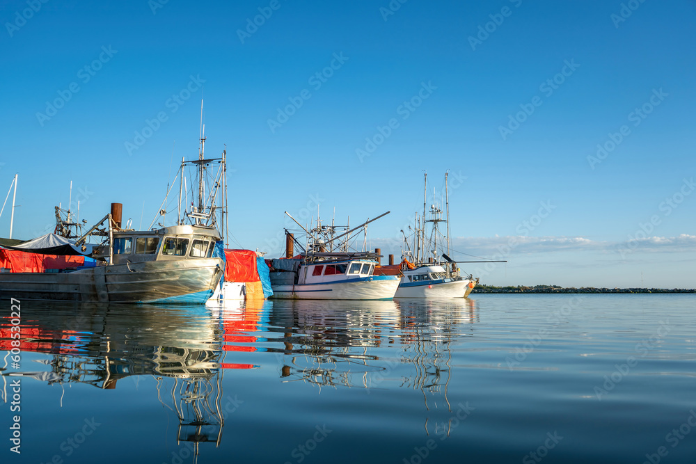 fishing boats docked in the wharf harbor