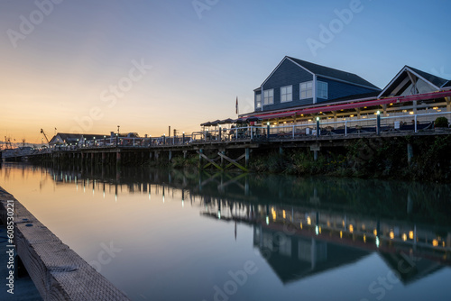 restaurant at the pier showing reflection on the calm water at sunset