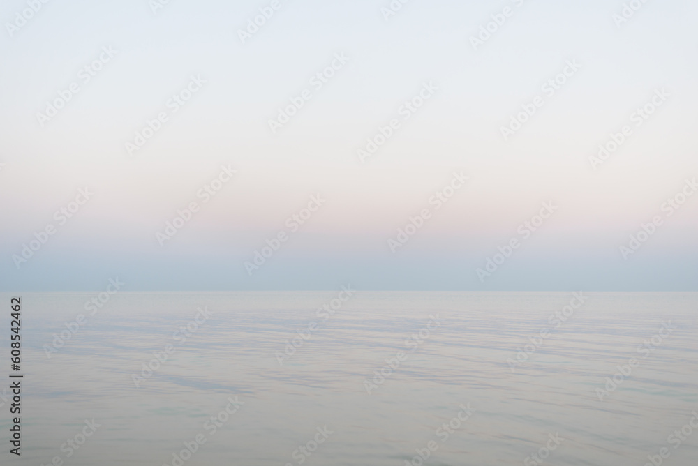 Obraz premium Neutral pastel watercolor gradient texture background, soft colored sea and sky during the down, beautiful aesthetic marine landscape