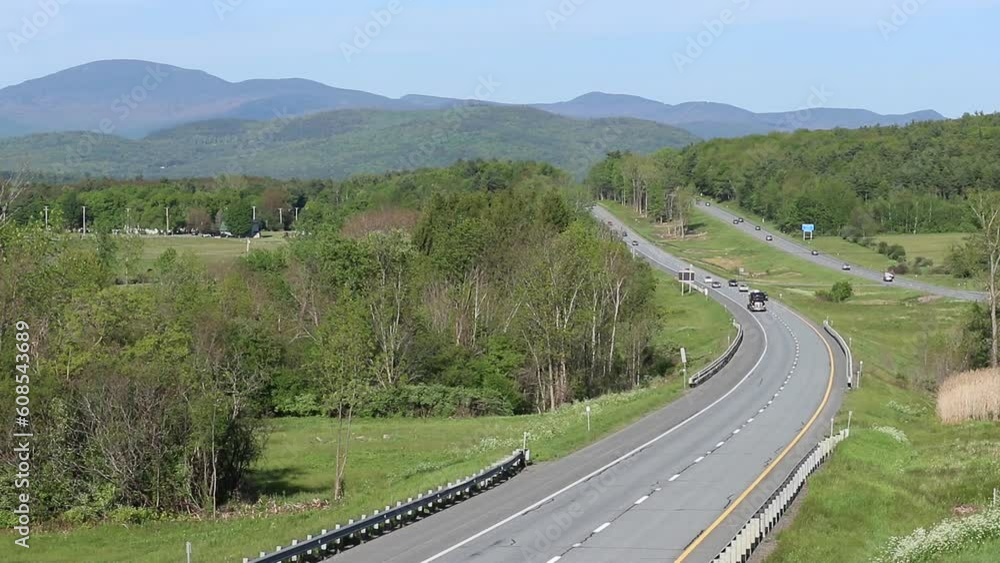 Cars drive on I89 in the mountains of Vermont. A hilly interstate road. Cars drive on I89 in the mountains of Vermont. A hilly interstate road.