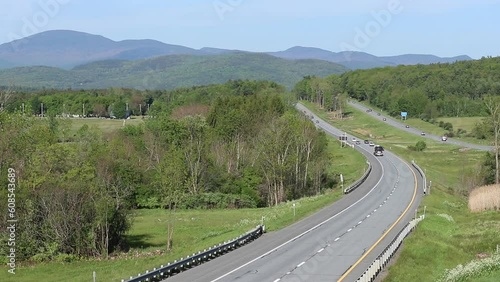 Cars drive on I89 in the mountains of Vermont.  A hilly interstate road. photo