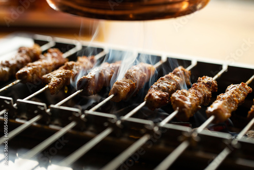Grilled lamb skewers over charcoal 