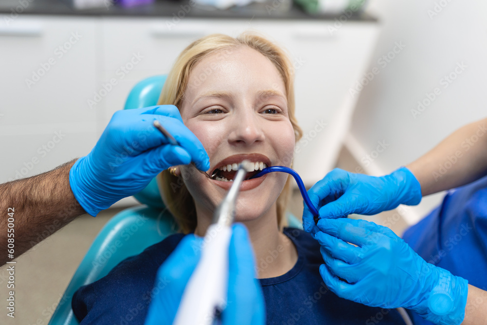 Teeth health concept. Cropped photo of smiling woman mouth under treatment at dental clinic, panorama Teeth health concept. Cropped photo of smiling woman mouth under treatment at dental clinic, panorama