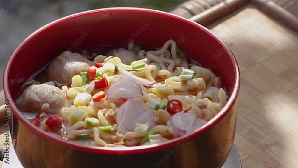 instant noodles with meatballs and sliced red chilies, shallots and scallions instant noodles with meatballs and sliced red chilies, shallots and scallions