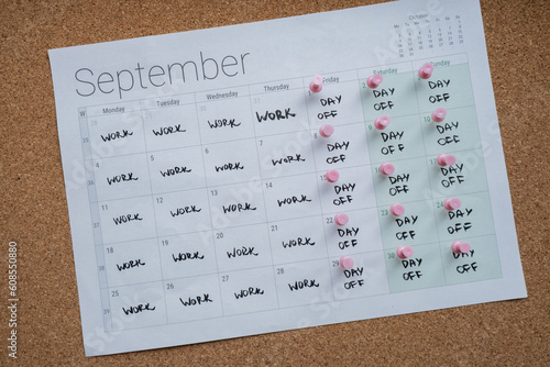 4 day work week printed calendar with pink pins on three days off in week weekend days four day working week concept. Modern approach doing business short workweek. Effectiveness of employees photo