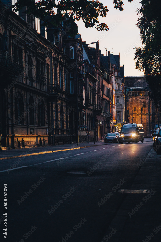Trier during sunset. Early evening. Lone van driving through a main street in the city.