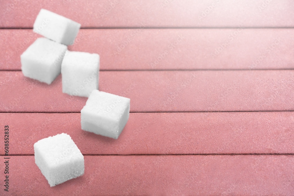 Pile of sugar and cubes on color background Pile of sugar and cubes on color background