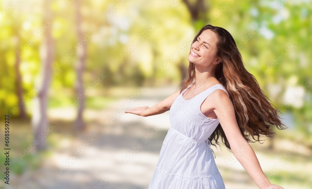 Carefree young girl laughing in the park, enjoying sunny day Carefree young girl laughing in the park, enjoying sunny day