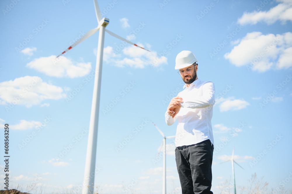 Engineer in field checking on turbine production Engineer in field checking on turbine production