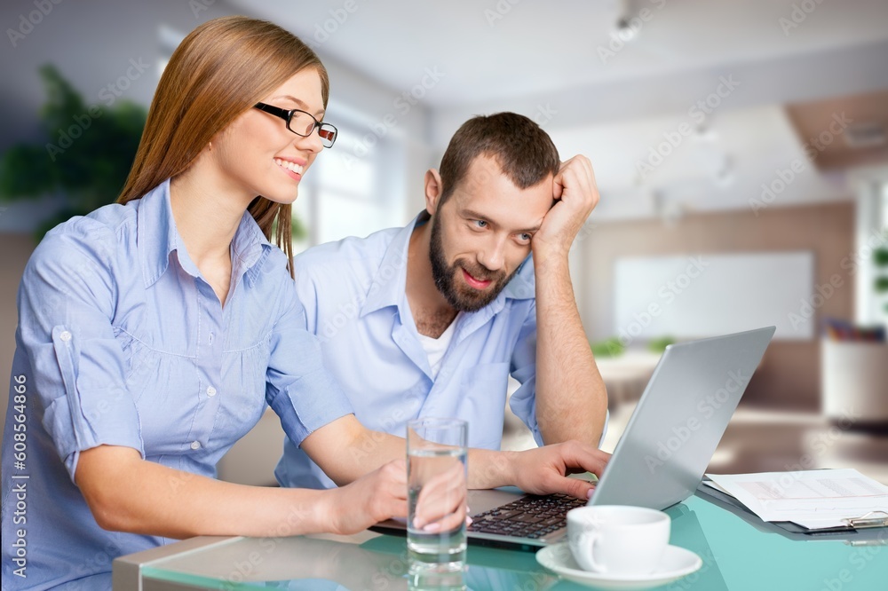 Business people looking something in laptop computer Business people looking something in laptop computer