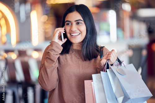Shopping, phone call and Indian woman in mall with smile for communication, conversation and chat. Retail, fashion and happy female person talking on smartphone for sale, bargain and discount news