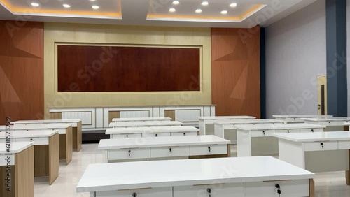 Empty classroom with white desks in a bright and new room photo