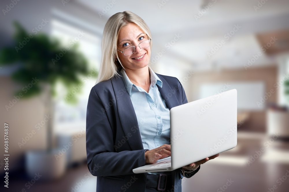 Beautiful young business woman using laptop Beautiful young business woman using laptop
