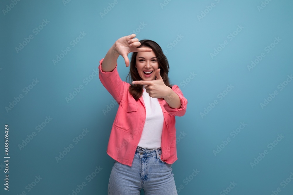 cheerful brunette young female adult in a shirt with joyful emotions on an isolated background cheerful brunette young female adult in a shirt with joyful emotions on an isolated background