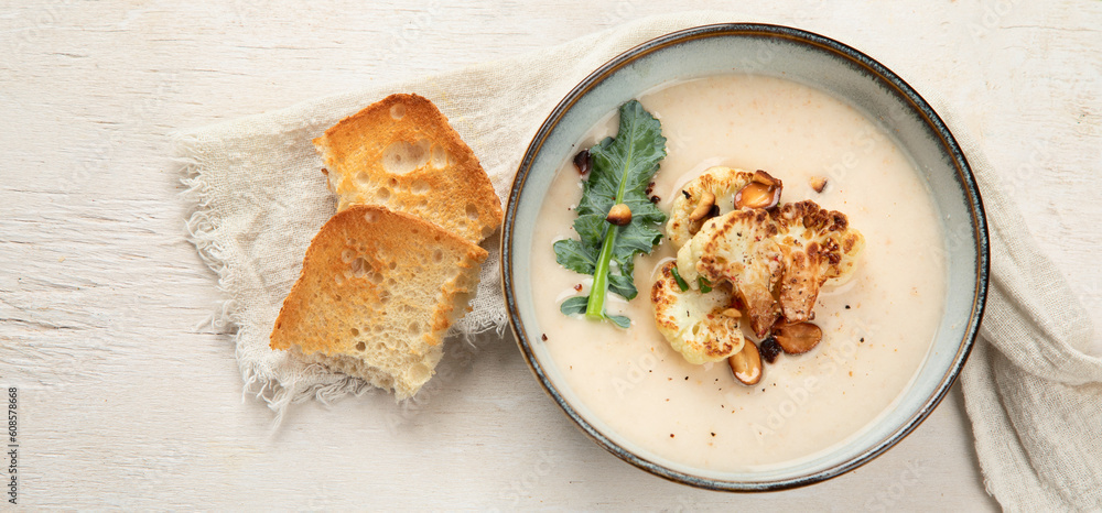 Roasted cauliflower soup served with grilled bread. Roasted cauliflower soup served with grilled bread.